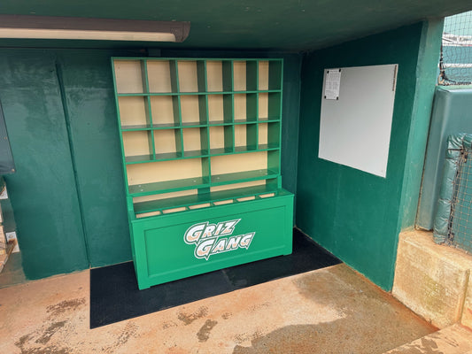 Green storage unit with shelves and a 'Griz Gang' sign in an indoor setting.