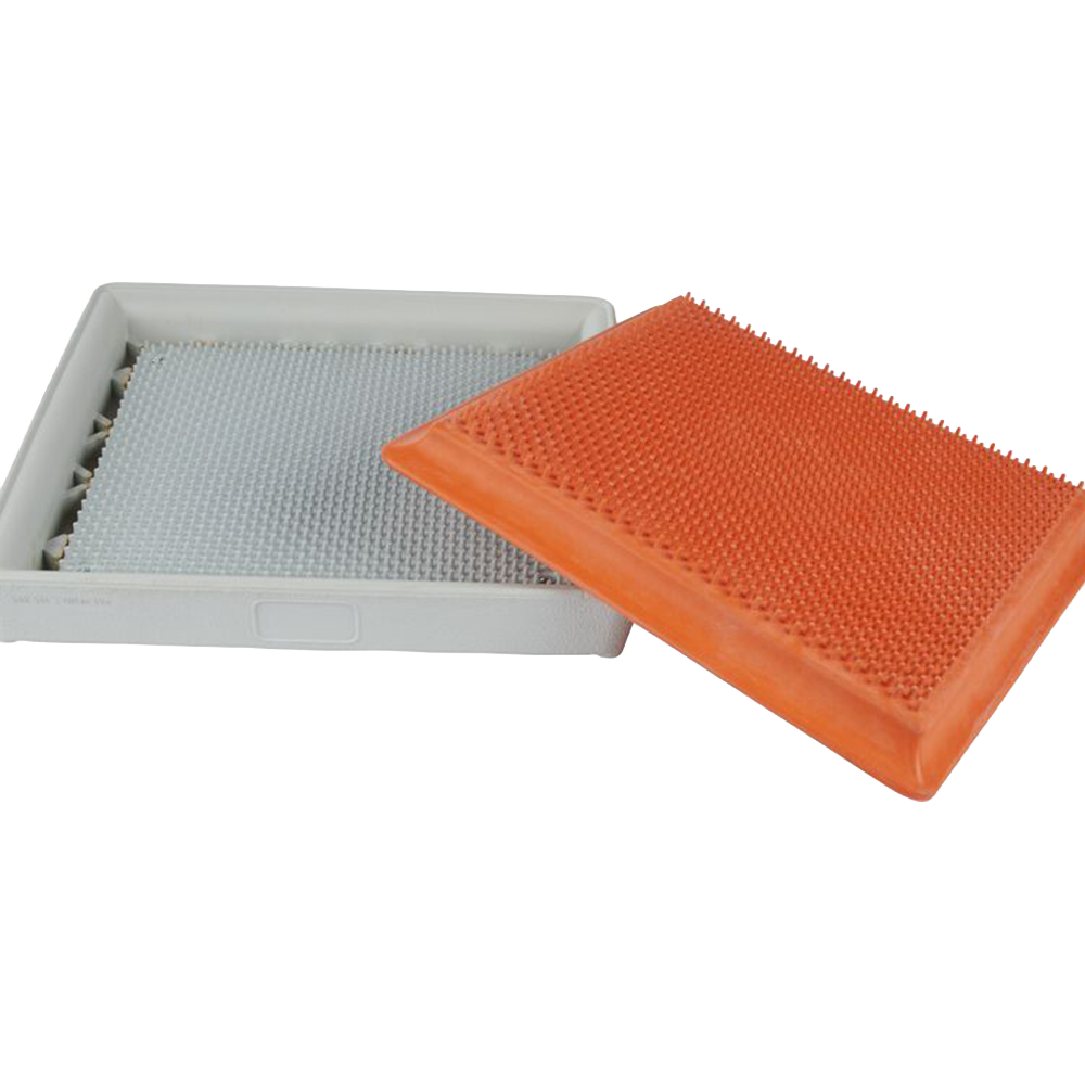 Bottom of the Hollywood base with the orange quick release insert slanted on top of the white base