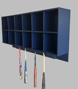 A blue 12 Helmet Combo Rack mounted on a wall, holding several baseball and softball helmets in its compartments, with bats hanging on the rack.