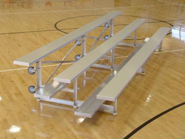 Aluminum Tip N' Roll Bleachers on a wooden gym floor