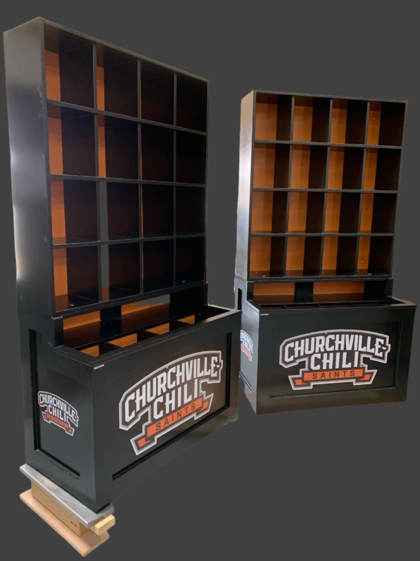 Two black shelving units with 'Churchville Chili' branding in a warehouse setting.