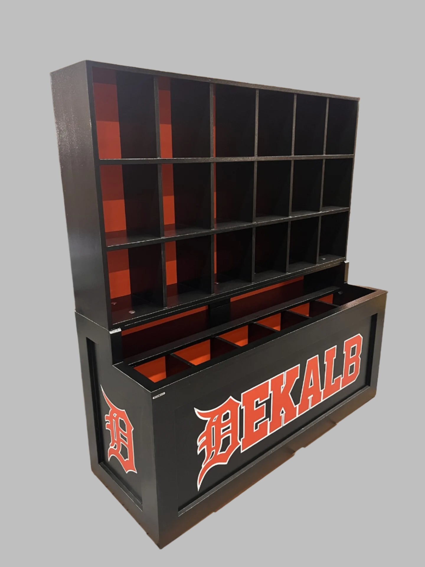 Black and orange storage unit with 'DEKALB' branding on a pallet in a warehouse.