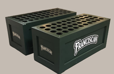 Two green wooden bat racks with the text 'FRANCISIAN' on the side, designed to hold baseball or softball bats.