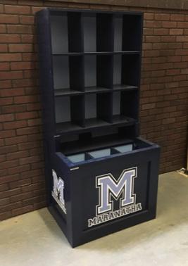 Navy Blue helmet and bat rack combination unit with the team logo 'M' on the front and sides, standing in a dugout setting.