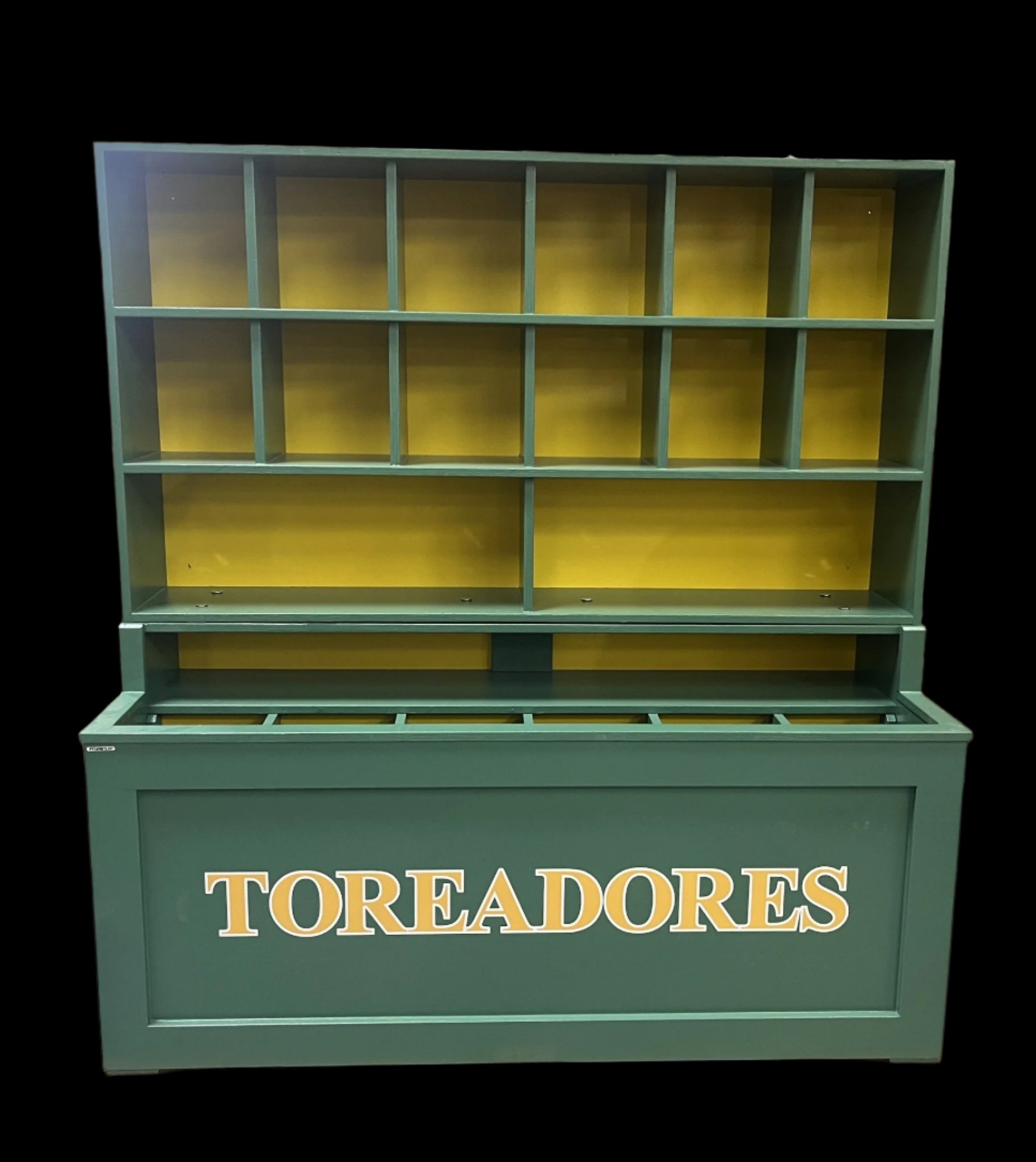 Green and yellow storage unit with 'TOREADORES' branding on a pallet in an indoor setting.